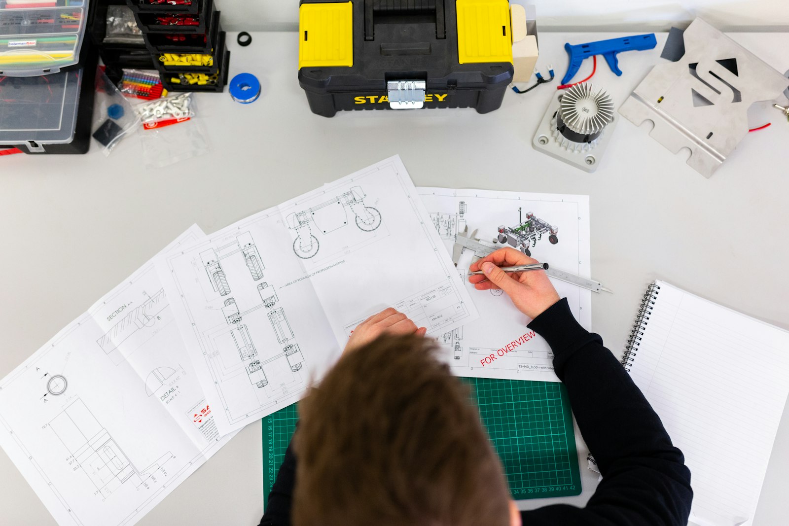 Engineer reviewing technical drawings and components